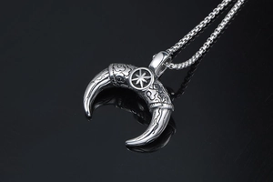 Close-up of vintage titanium steel moon pendant necklace with intricate engravings