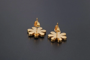 Detailed back view of gold daisy stud earrings showing secure butterfly earring backs