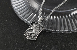 Macro shot of retro stainless steel shield pendant featuring detailed unicorn relief