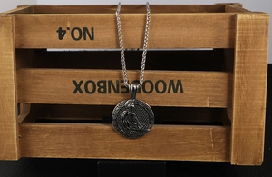 Macro detail of Roman Spartan warrior relief pendant with Great Wall pattern edge