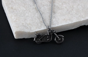 Macro detail of retro stainless steel motorcycle pendant with oxidized silver finish