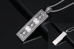 Macro view of retro square pendant with engraved eight-point stars and brushed metal back