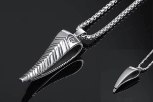 Detailed view of silver antelope horn pendant with V-shaped texture on box chain