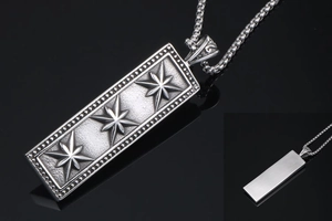 Macro detail of vintage rectangular pendant featuring triple star relief and beaded border
