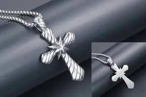 Vue détaillée d'un pendentif croix vintage argenté avec motif d'étoile et lignes gravées