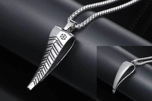 Macro view of polished silver antelope horn pendant with detailed horizontal textures
