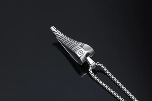 Close-up of titanium steel antelope horn pendant with detailed grooves and bead chain