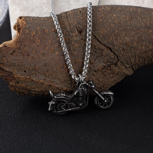 Retro motorcycle pendant necklace in vintage silver steel with a rustic bark background