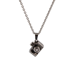 Elegant stainless steel necklace featuring a vintage camera pendant with metallic texture