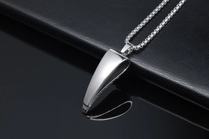 Macro view of polished silver geometric antelope horn pendant with stainless steel chain