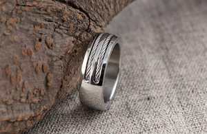 Detailed view of wide men's stainless steel ring featuring dual steel cable wire inlay