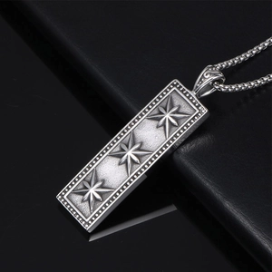 Vintage silver rectangle pendant with three 8-point stars on a black leather background