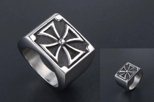 Close-up of vintage titanium steel men's ring featuring a detailed cross relief design