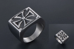 Detail of silver signet ring with engraved Maltese cross on rectangular steel surface