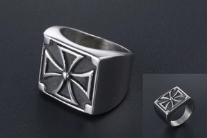 Macro detail of men's heavy stainless steel signet ring with maltese cross relief design