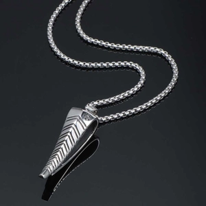 Polished silver titanium antelope horn pendant necklace for men on black reflective surface