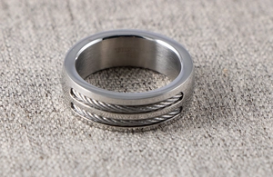 Macro view of stainless steel ring featuring dual steel cable inlay and polished edges