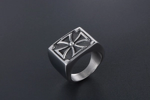 Macro shot of retro stainless steel signet ring with embossed Maltese cross design