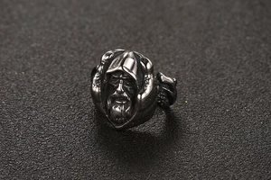 Detailed close-up of retro titanium steel ring featuring a carved bearded man figure