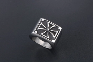 Detailed macro view of vintage square titanium steel ring with embossed cross design