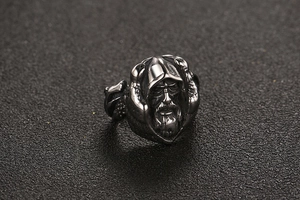 Macro shot of vintage titanium steel ring featuring an old man wizard carving in silver