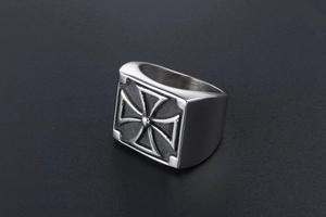 Macro view of men's stainless steel signet ring with embossed Iron Cross design detail