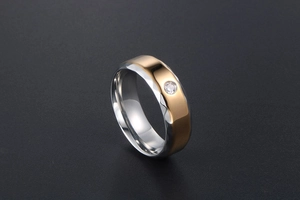 Détail macro d'une bague bicolore en acier avec un oxyde de zirconium étincelant