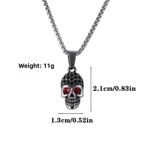 Detail view of skull pendant with red stone eyes and dimensions: 2.1cm height, 1.3cm width
