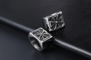 Detail of two vintage silver titanium steel cross rings on textured black leather