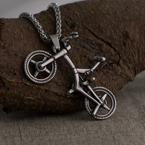 Retro stainless steel bicycle pendant necklace for men with wheat chain on rustic wood