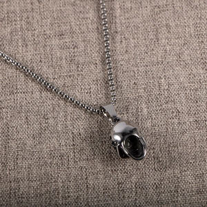 Gothic skull pendant necklace with red eye accents in polished vintage stainless steel