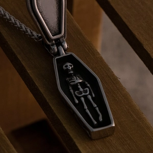 Gothic stainless steel coffin pendant necklace with hidden skeleton inside on wood
