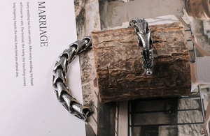 Detail of silver dragon scale links and carved dragon head clasp on vintage steel bracelet