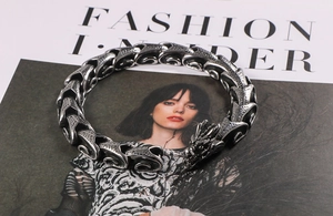 Detailed close-up of retro dragon head bracelet with intricate dragon scale chain links