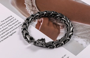 Detail of vintage dragon scale link bracelet with dragon head clasp in aged titanium steel