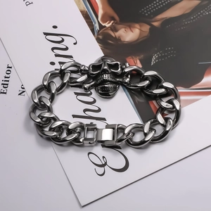 Close-up of punk skull centerpiece on silver stainless steel heavy Cuban chain bracelet