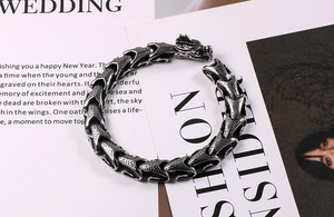 Macro detail of vintage dragon head bracelet featuring intricate scale patterns and silver finish