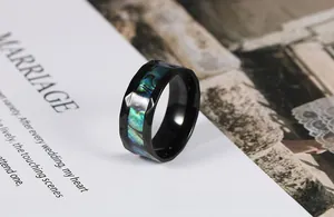 Macro view of men's black rhombus cut ring inlaid with colorful iridescent abalone shell