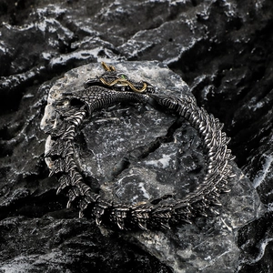 Vintage punk dragon head bracelet for men featuring golden horns and green eyes