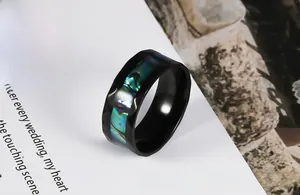 Macro view of black rhombus cut stainless steel ring with colorful abalone shell inlay