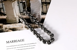 Macro shot of vintage titanium steel skull bracelet links over retro background