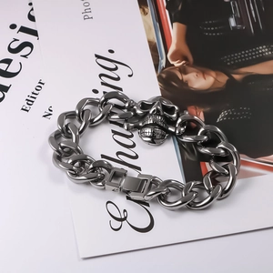 Punk titanium steel cuban link bracelet featuring a detailed skull and crossbones charm