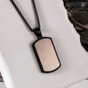 Industrial style square necklace with black metal frame and cross-brushed metal pendant