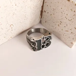 Detailed view of stainless steel ring with black enamel number 13 and bone texture