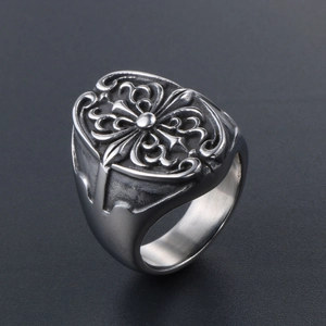 Close-up of gothic cross relief and intricate carvings on heavy punk titanium steel ring