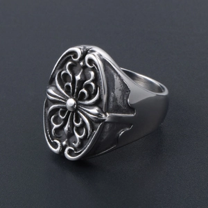 Close-up of vintage punk ring with embossed cross floral pattern in silver finish
