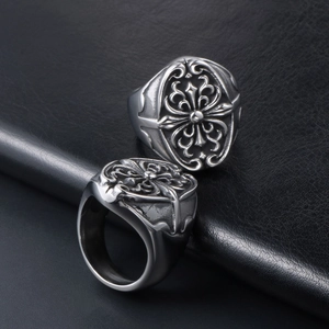 Macro shot of vintage gothic cross rings with black matte finish on leather surface