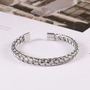 Detail of silver twisted wire cable bracelet showing intricate woven metal texture