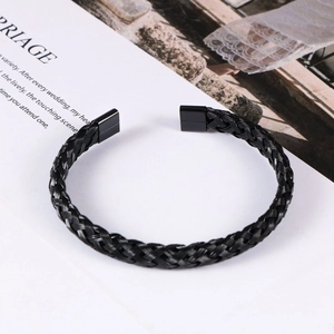 Detailed view of black braided stainless steel cable bracelet with polished flat end caps