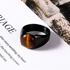 Men's matte black stainless steel ring featuring a natural tiger eye gemstone inlay